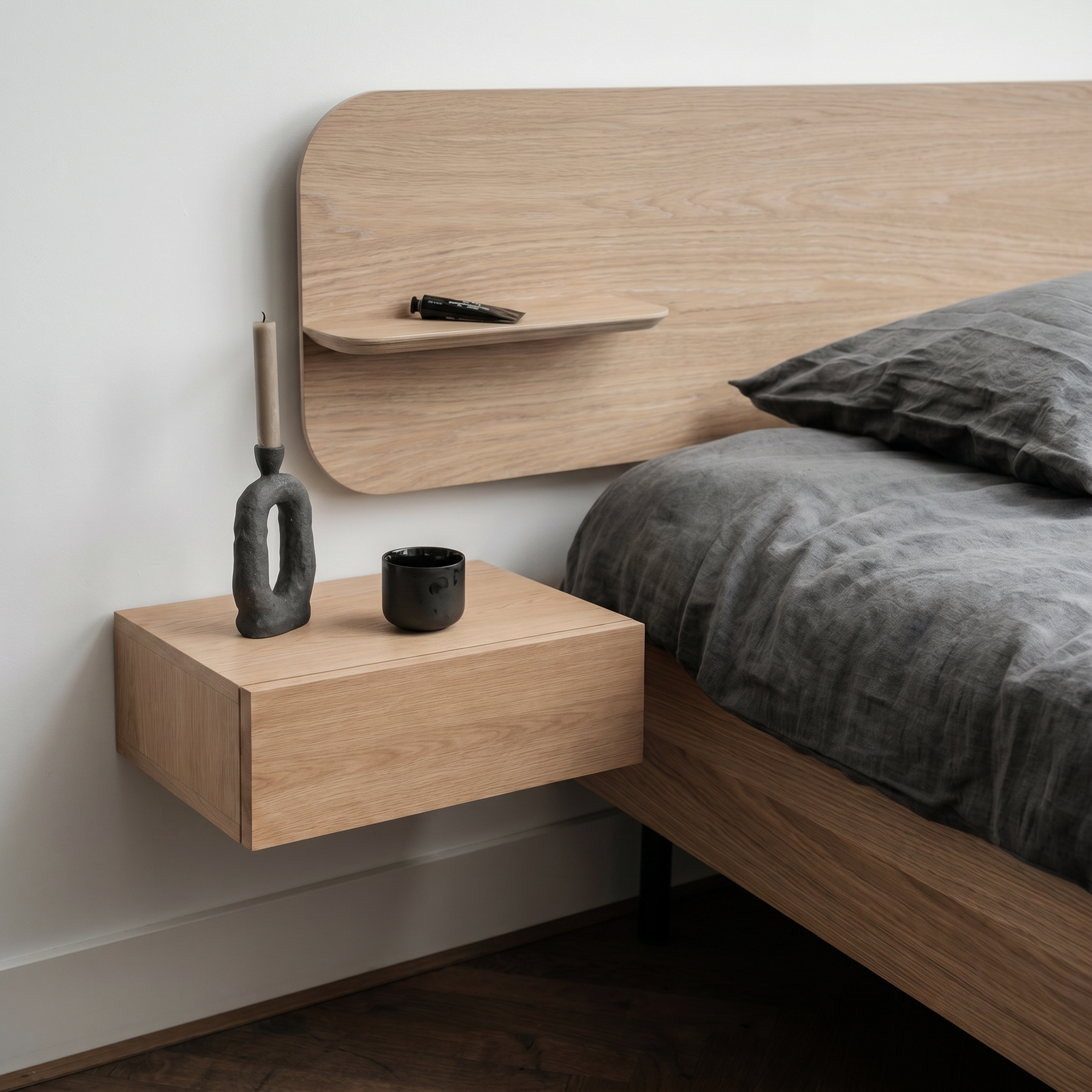 Solid oak floating bedside table beside a bed